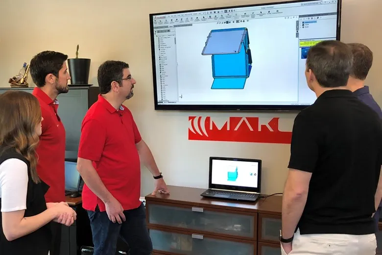 The Business Model Canvas: How Invention Makers Communicate Ideas 2 TriMech Design team discussing prototypes.