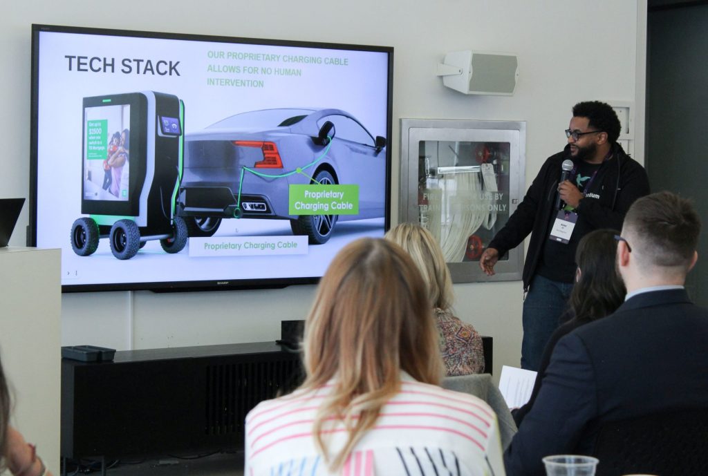 Kiwi Charge Robotic Electric Vehicle Charger Takes Top Prize in Student Pitch Competition at TMU 2 Abdel Ali presenting about Kiwi Charge