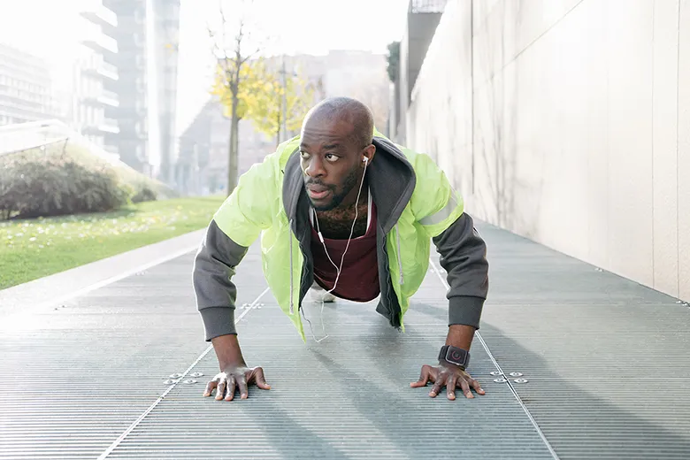 Young Athletic Man Exercising Outdoors Wearing A Fluorescent Jacket Kharaband